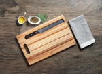Utility board with cut-out handle and bread crumb grooves (10 x 16 x 0.75 in)